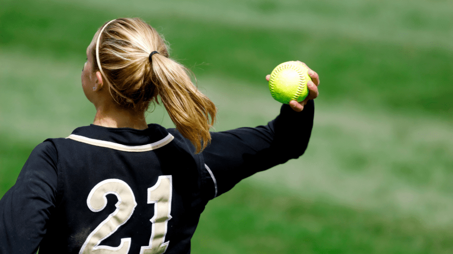 a girl throwing a softball