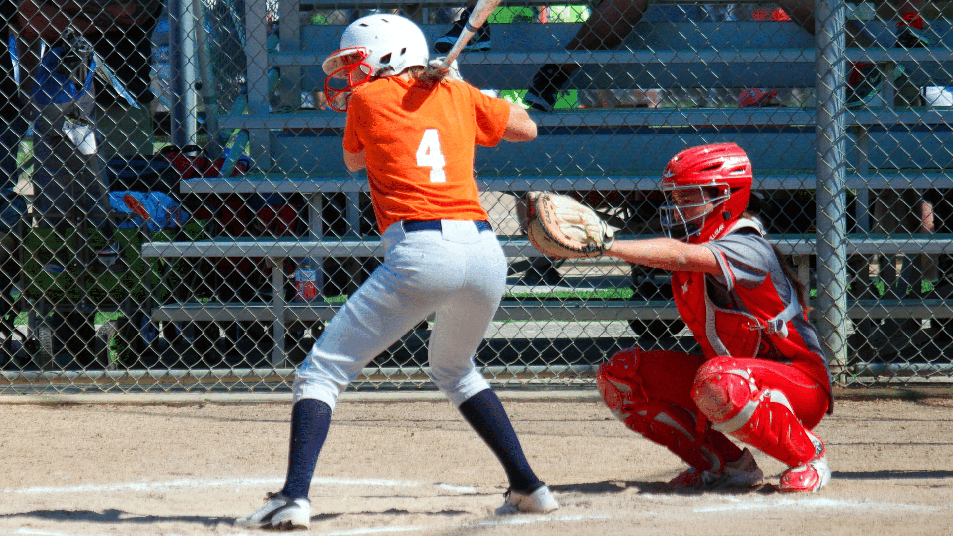 softball batter at home plate with catcher