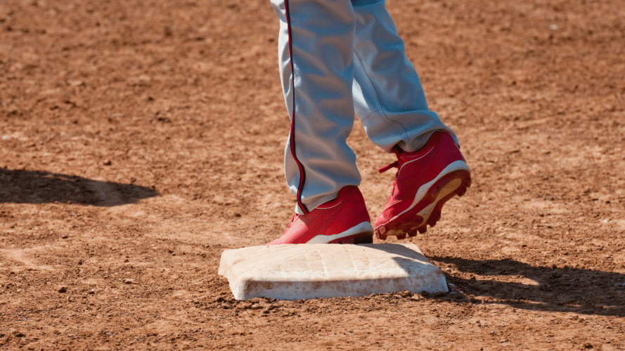 A close-up shot of red cleats on a base