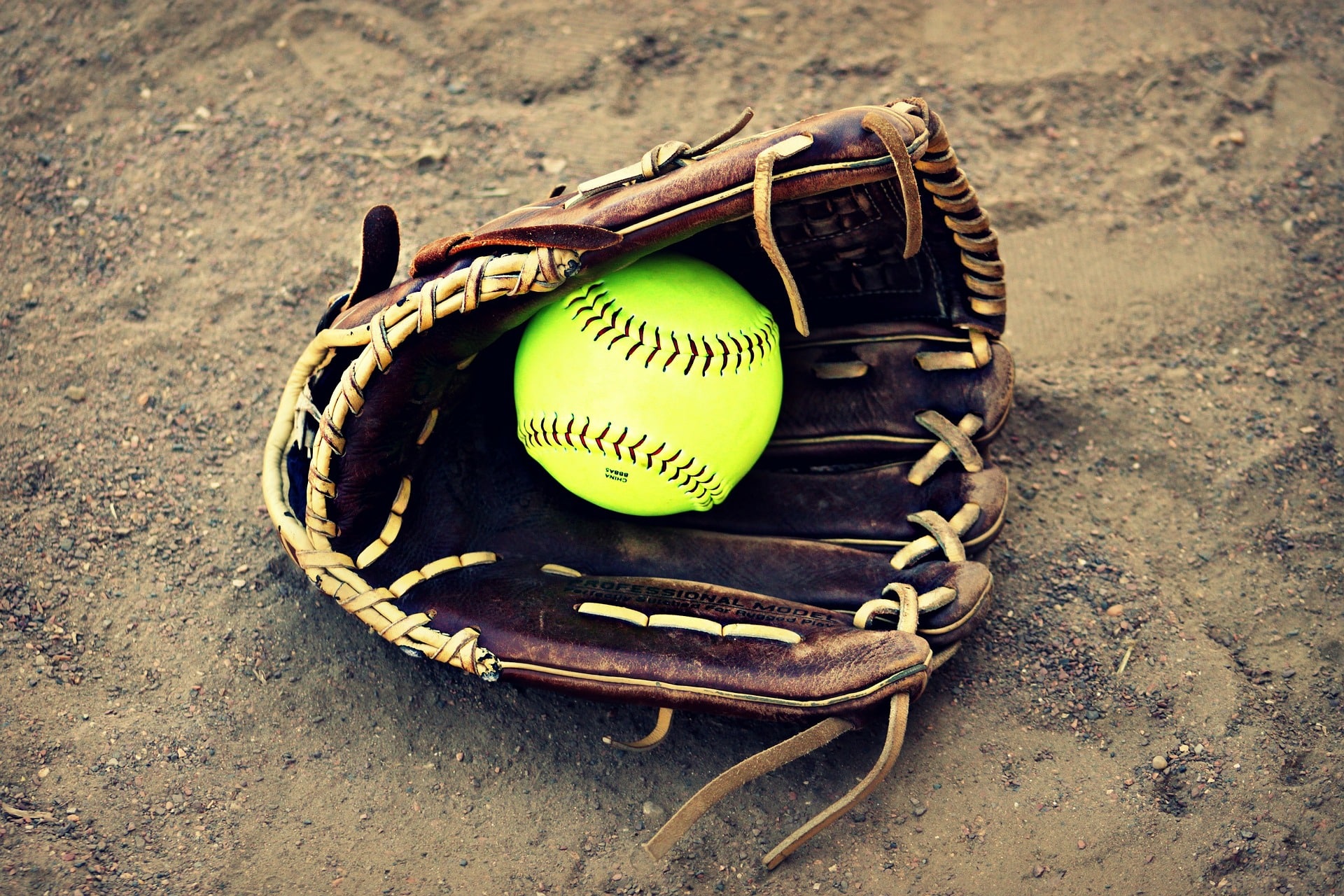 softball glove in dirt