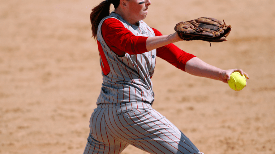 A softball pitcher about to throw a ball