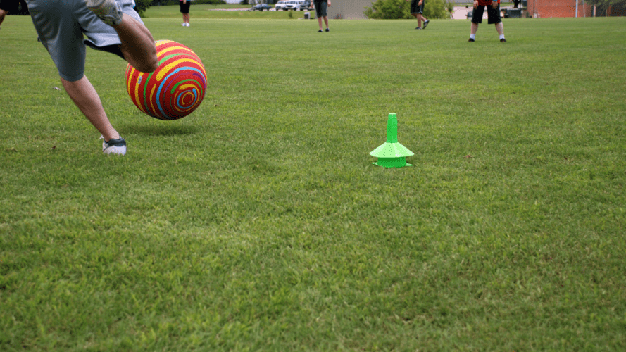 Playing kickball in the grass