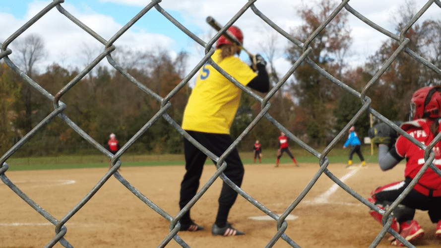Slowpitch game where yellow jersey is batting